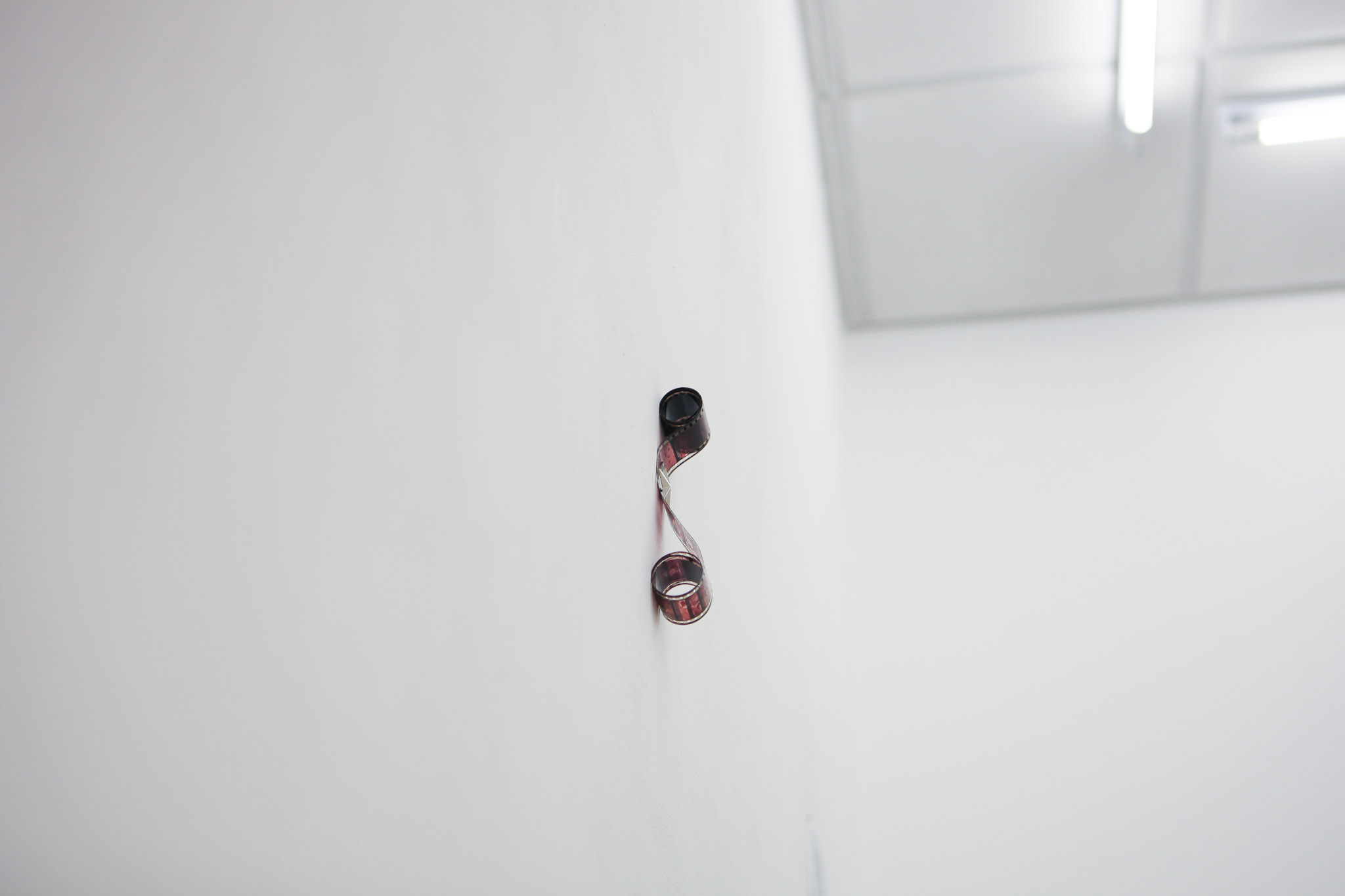 (Detail) <em>Leather jacket for rainy nights II</em>, 2024. leather jacket, steel, doll house lamp, DVDs, video loop 5'25, screen, desk speakers. Exhibition view: <em>Playlist for an eternal Autumn</em>, AA, Strasbourg, 2024. Photo © ALLOK7.FR